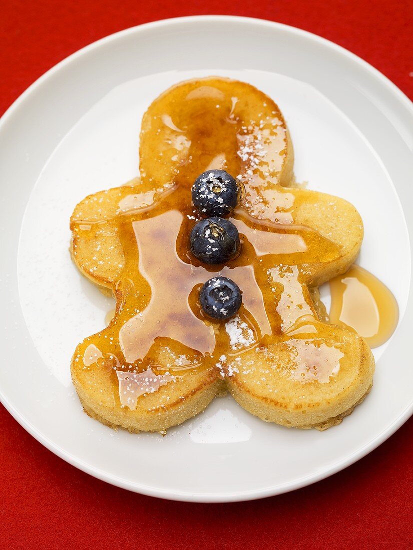 Pancake man with blueberries and maple syrup