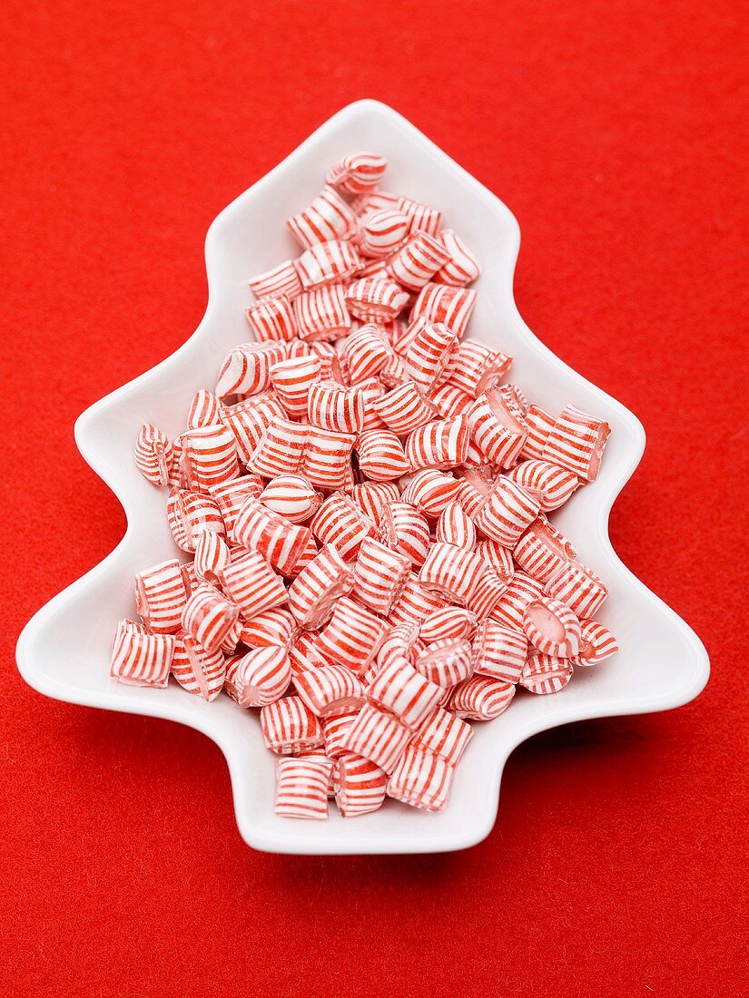 Red and white striped peppermints in dish