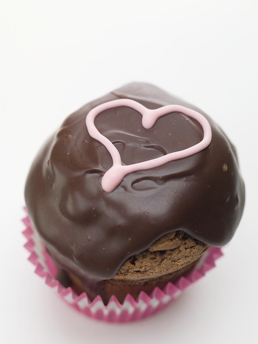 Cupcake with chocolate icing and pink heart