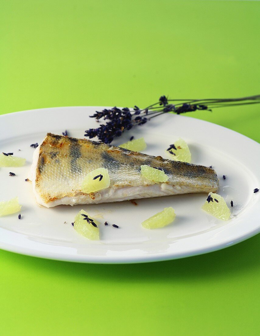 Fried zander with lavender flowers and lime segments