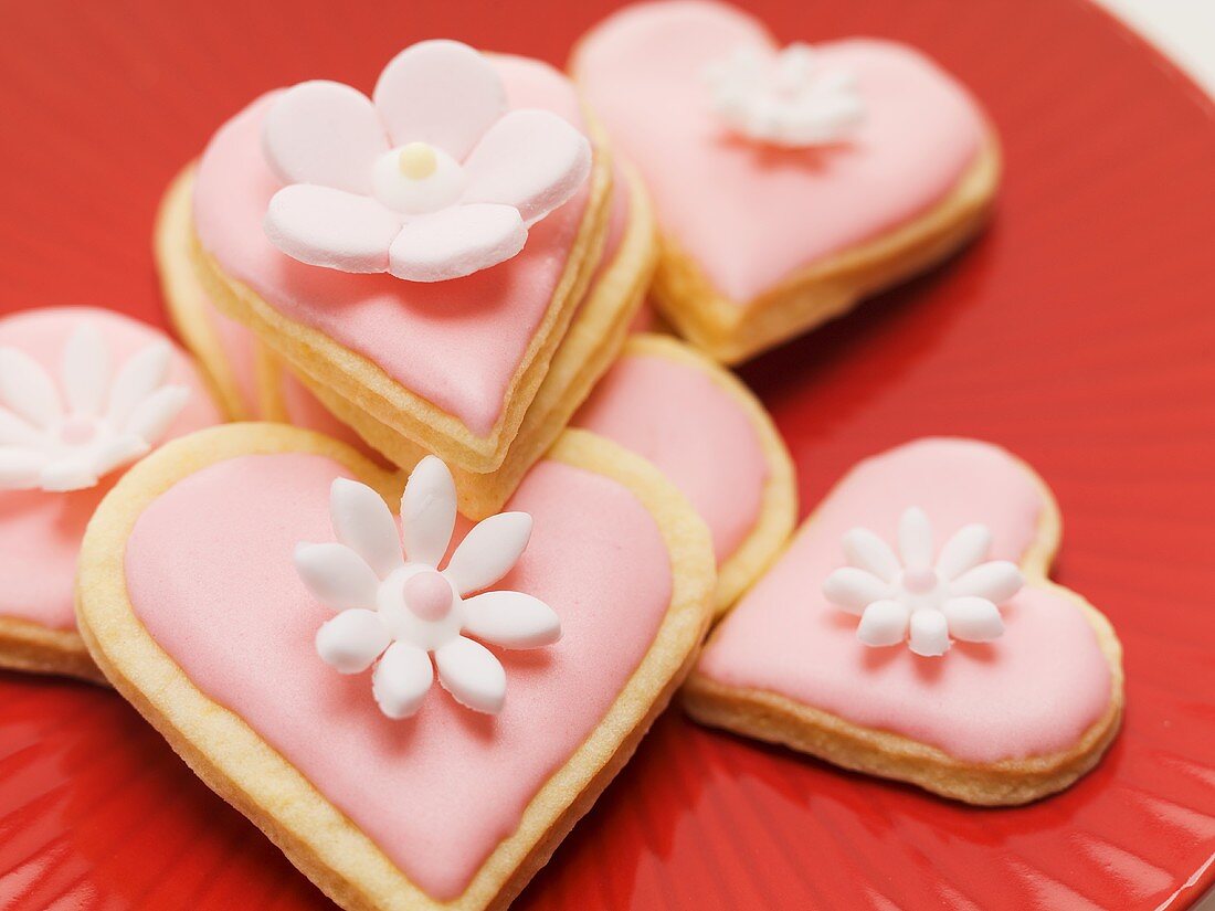 Pink heart-shaped biscuits with sugar flowers