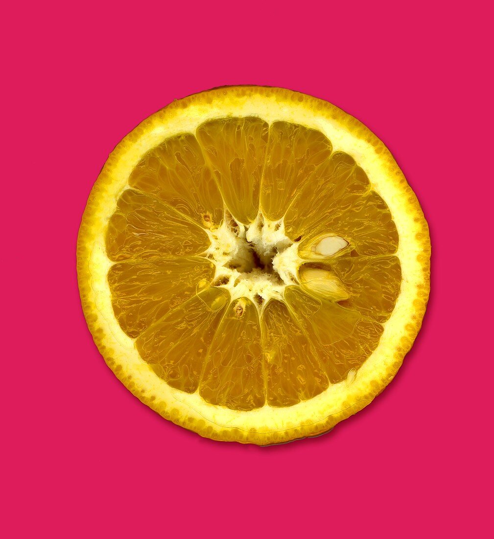 A slice of Jaffa orange against a red background