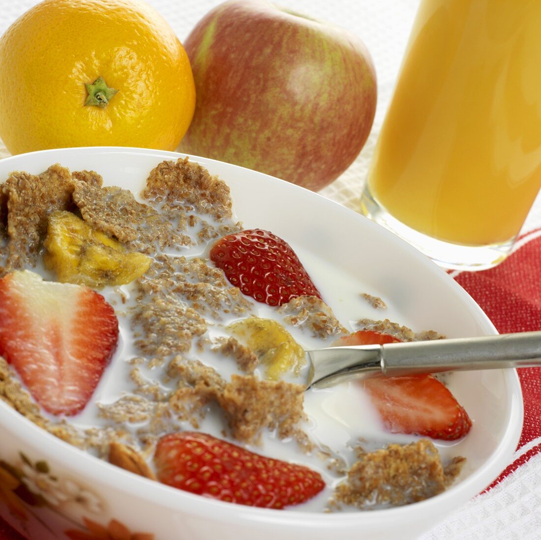 Cereal flakes with fruit and a glass of orange juice