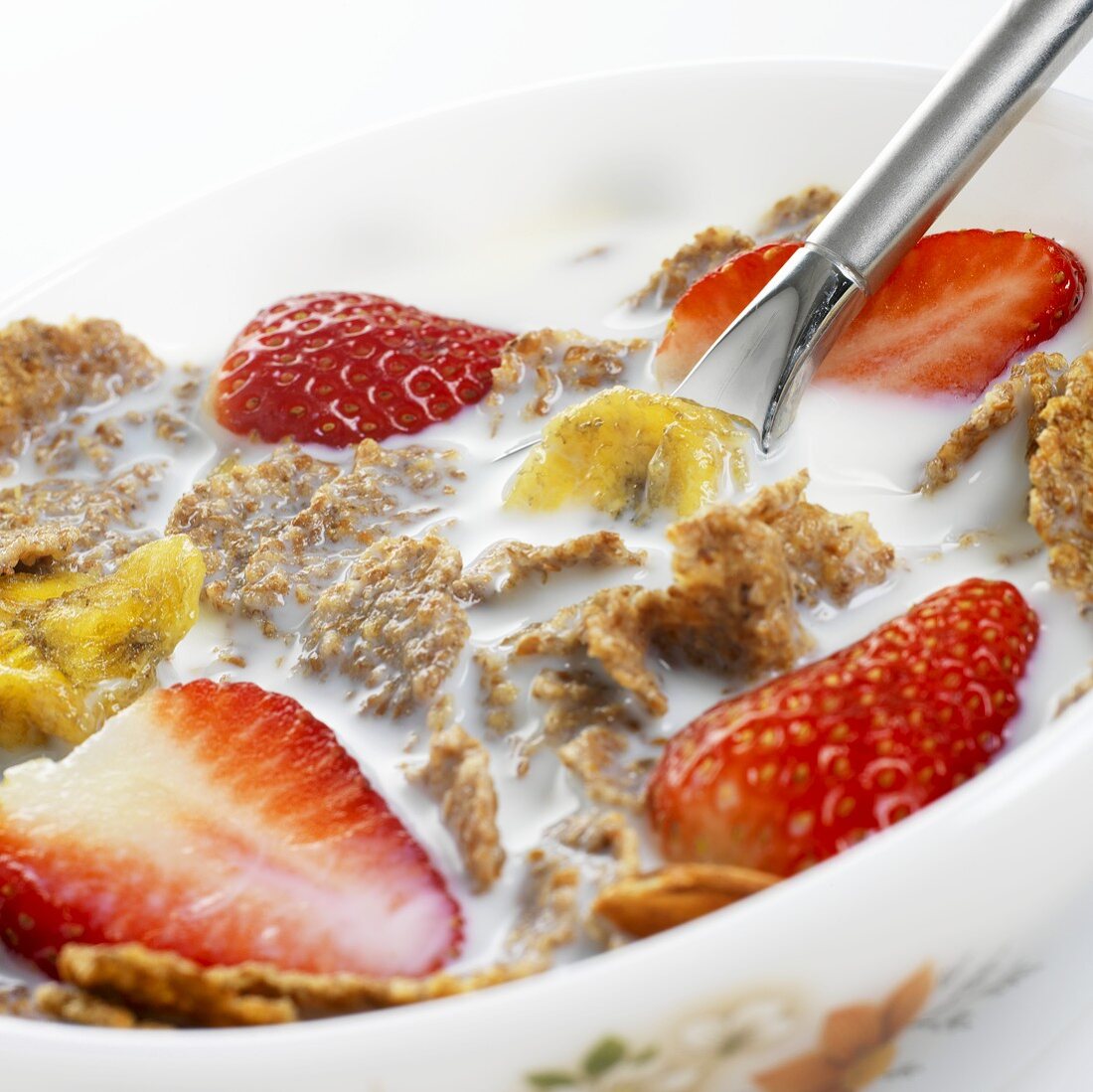 Frühstücksflocken mit Milch, Erdbeeren, getrockneten Bananen