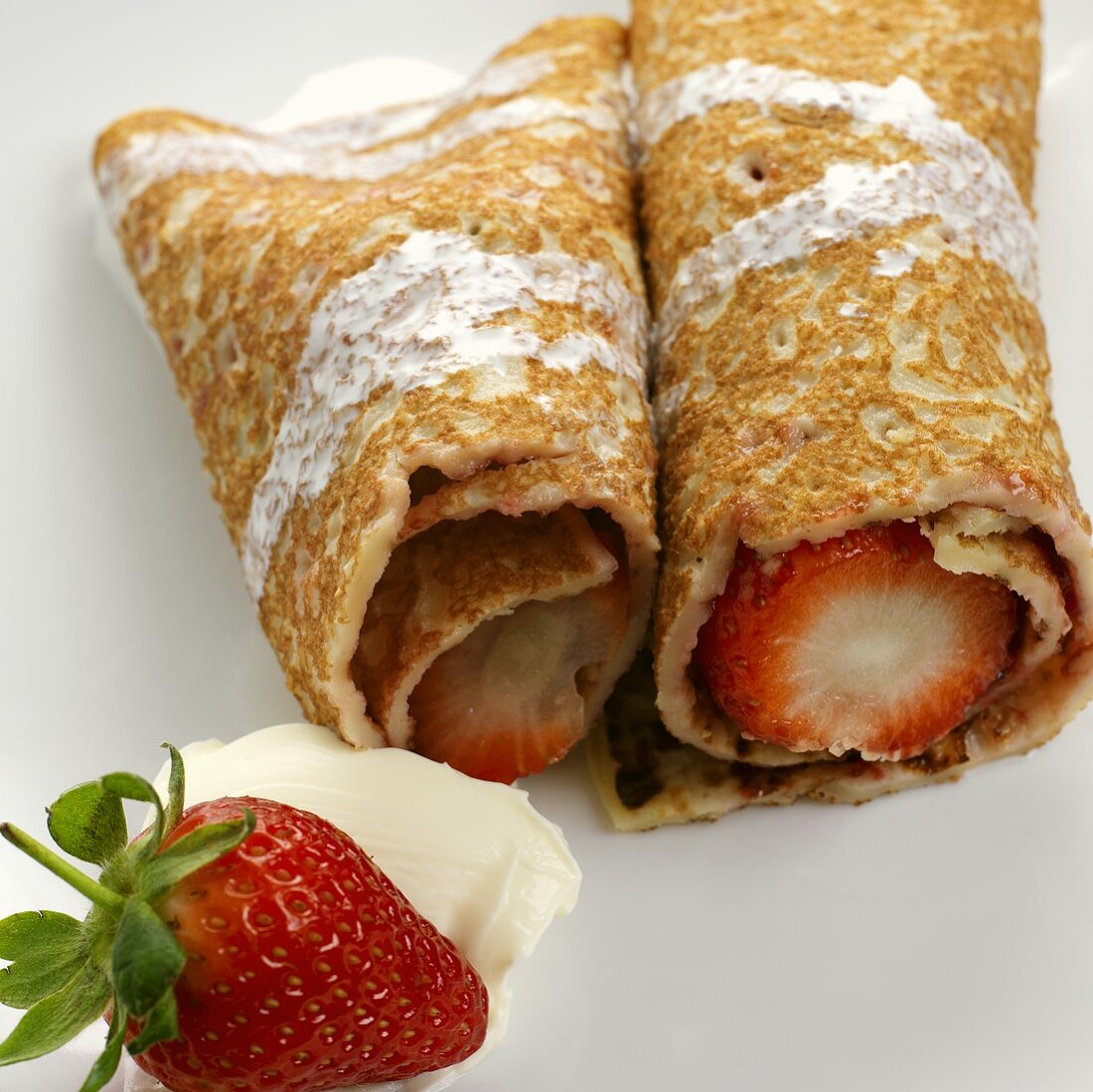 Pancakes filled with fresh strawberries and cream