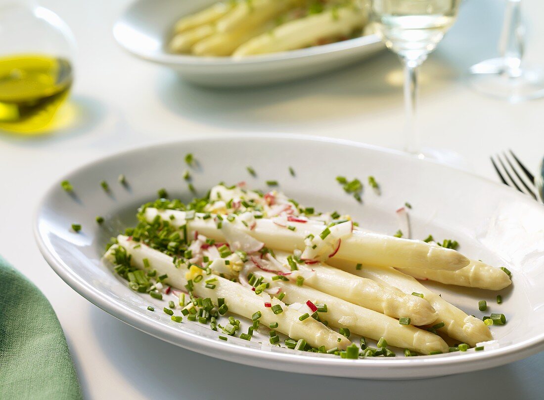Asparagus with radish and egg vinaigrette on a platter