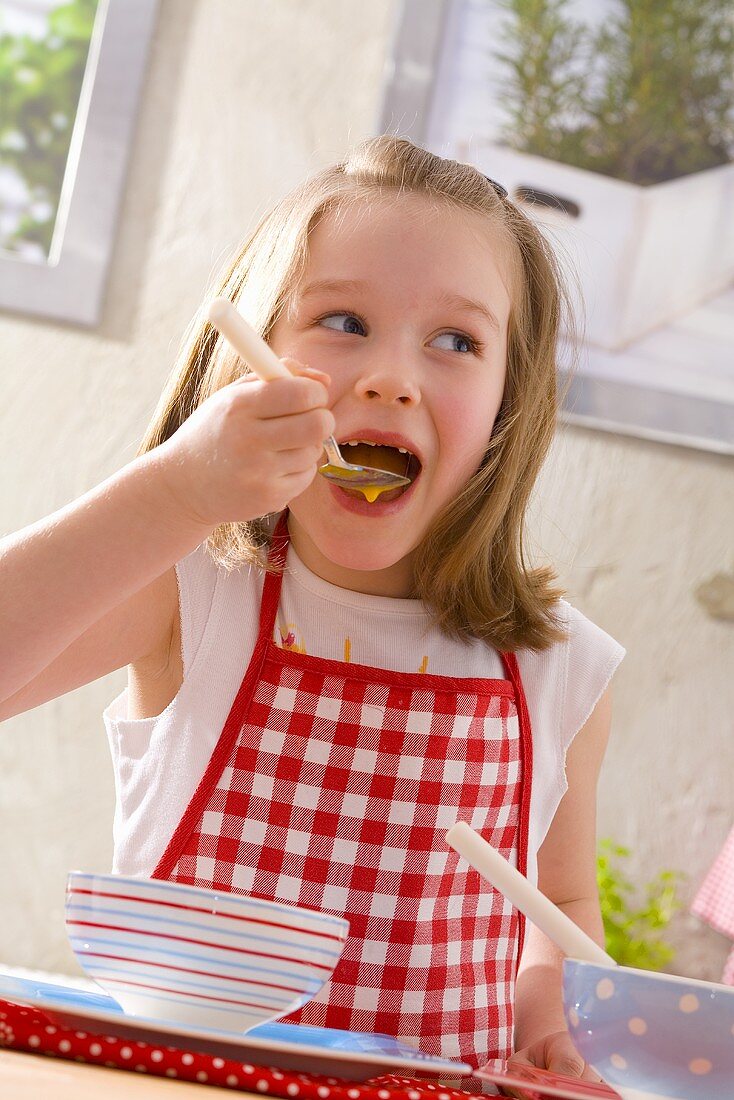 Girl eating pumpkin soup