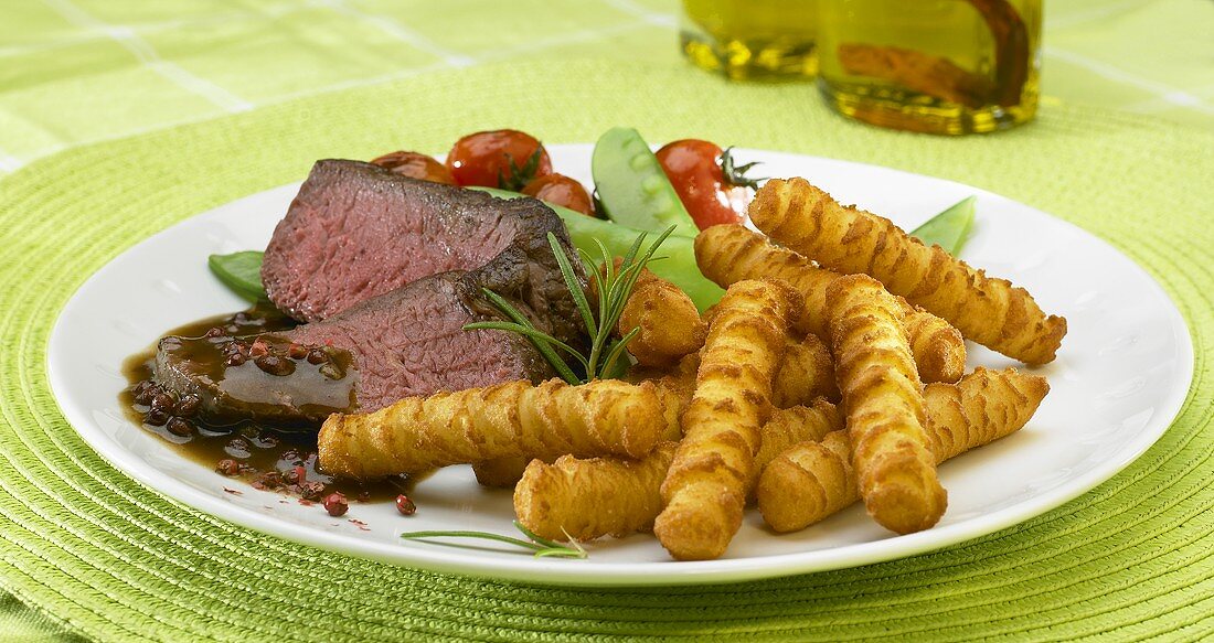 Fillet steak with red pepper sauce, potato croquettes and vegetables