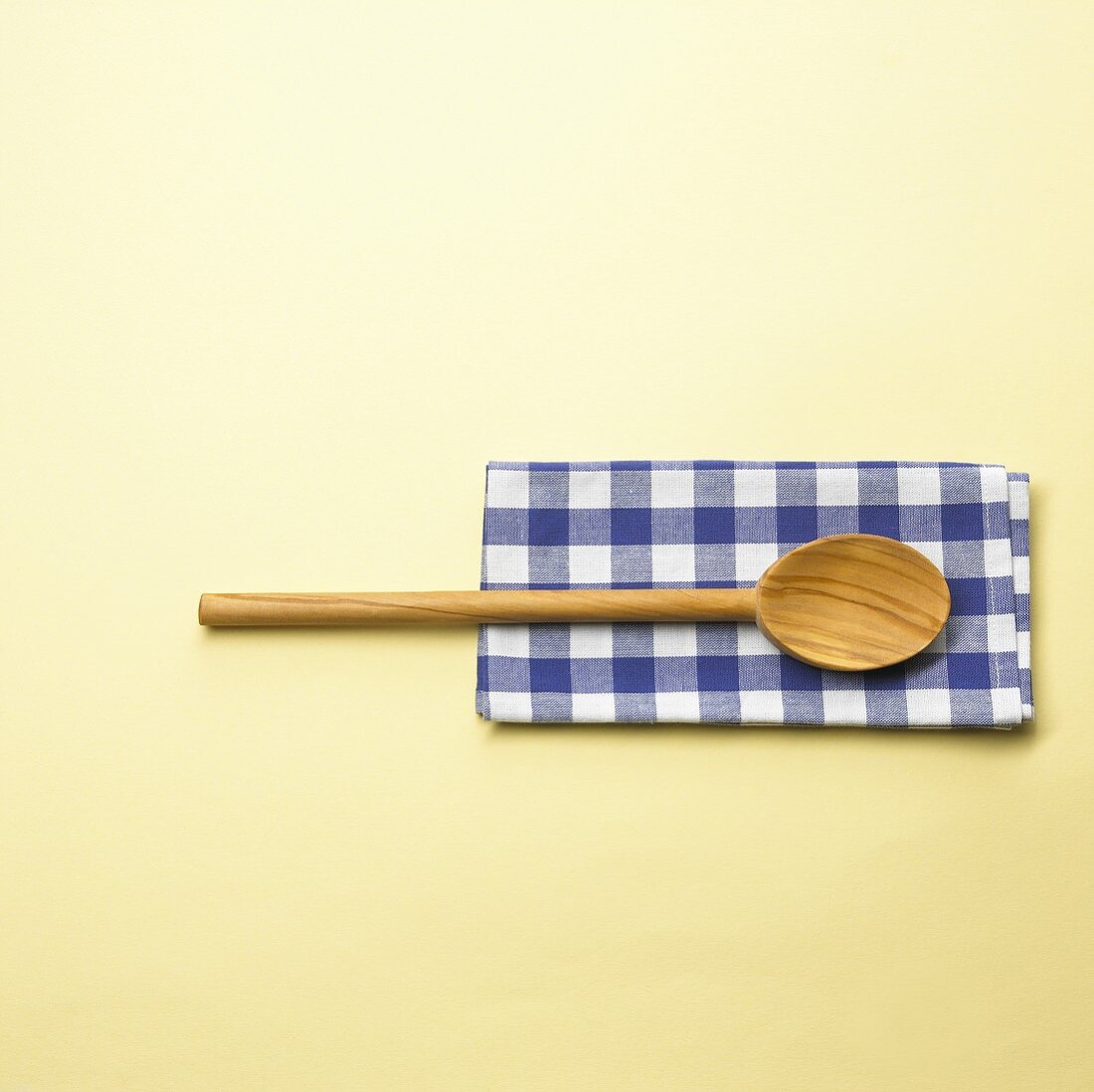 Wooden spoon on checked cloth