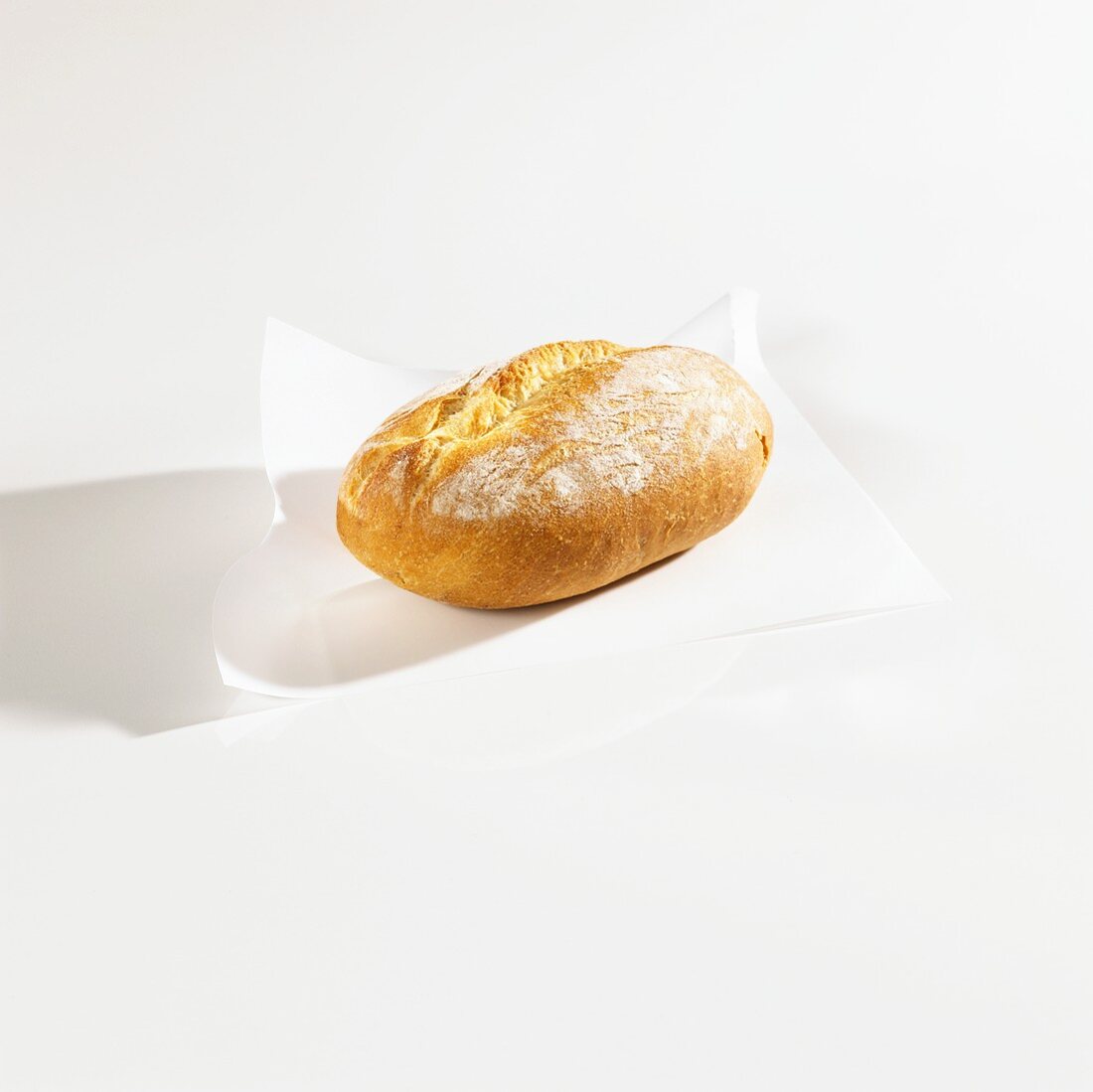 A bread roll on greaseproof paper