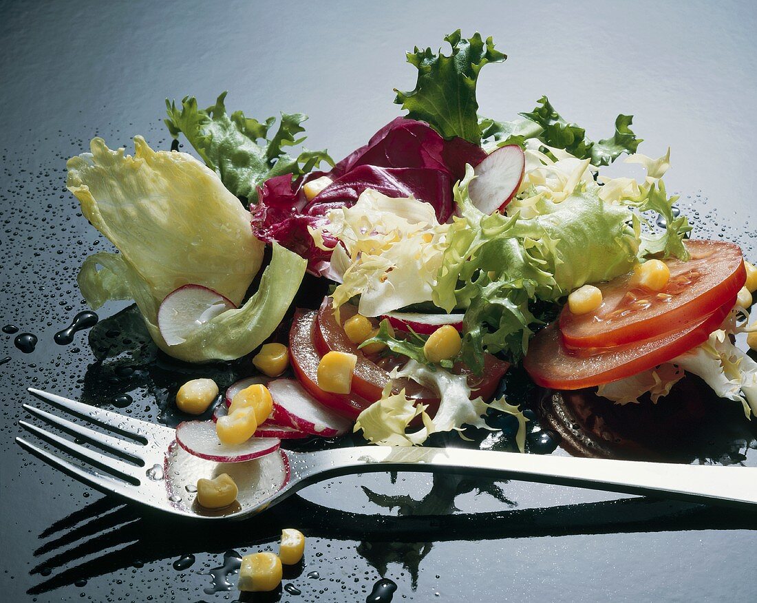 Mixed salad with fork