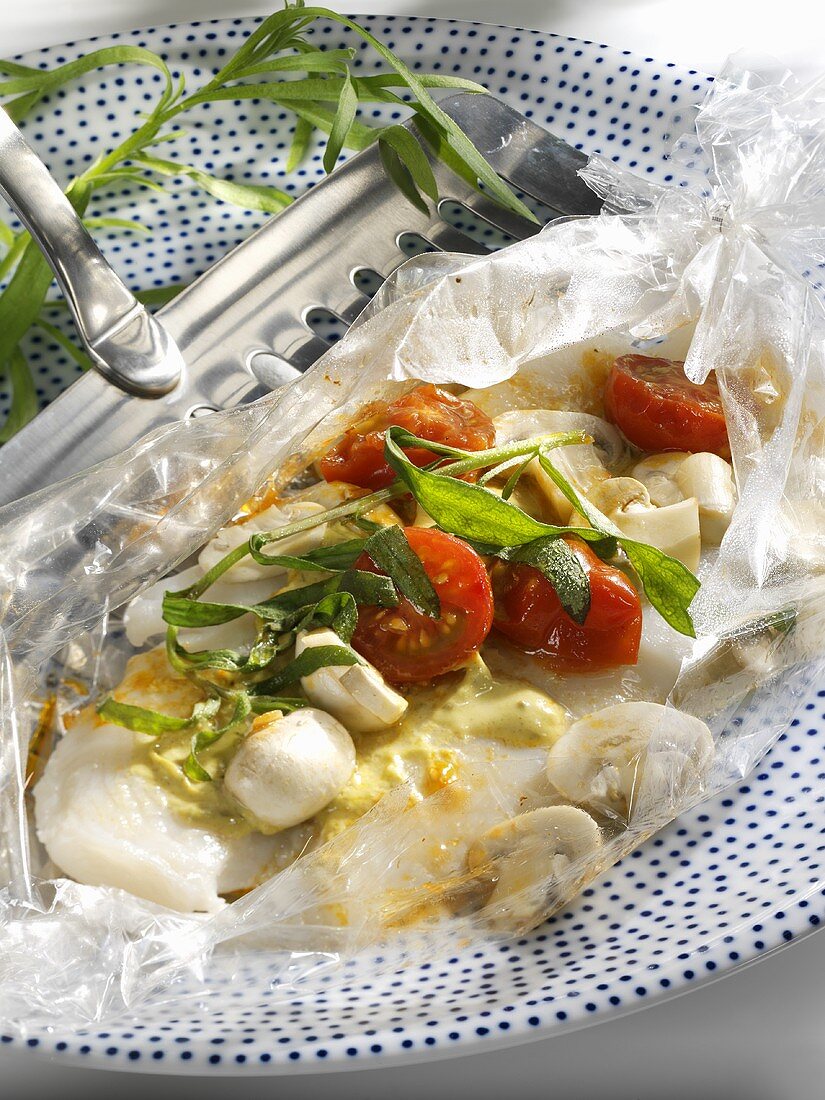 Fish fillet and vegetables cooked in roasting bag