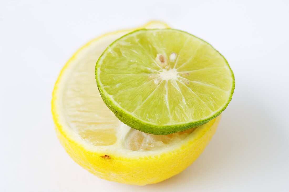 A slice of lime on half a lemon