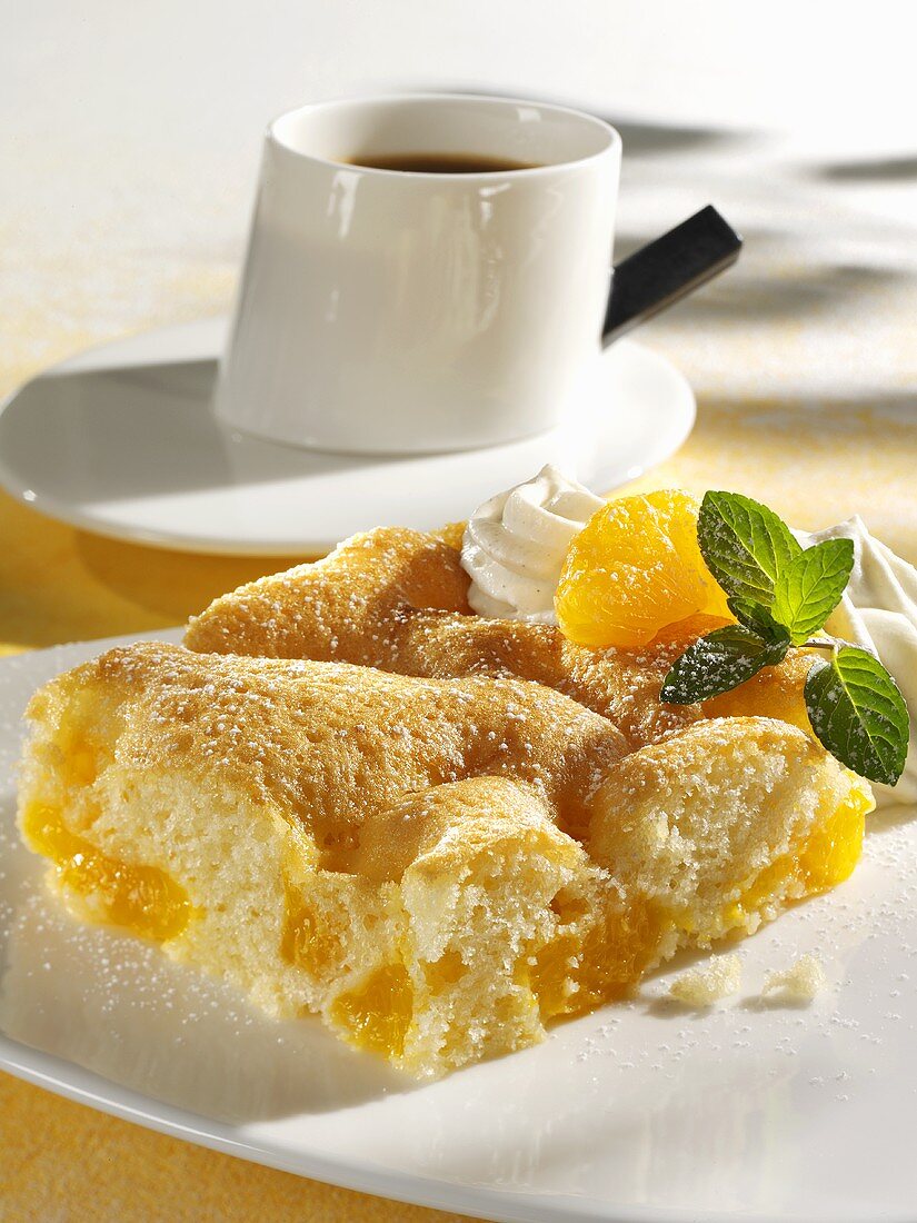 A piece of mandarin orange cake with a cup of coffee