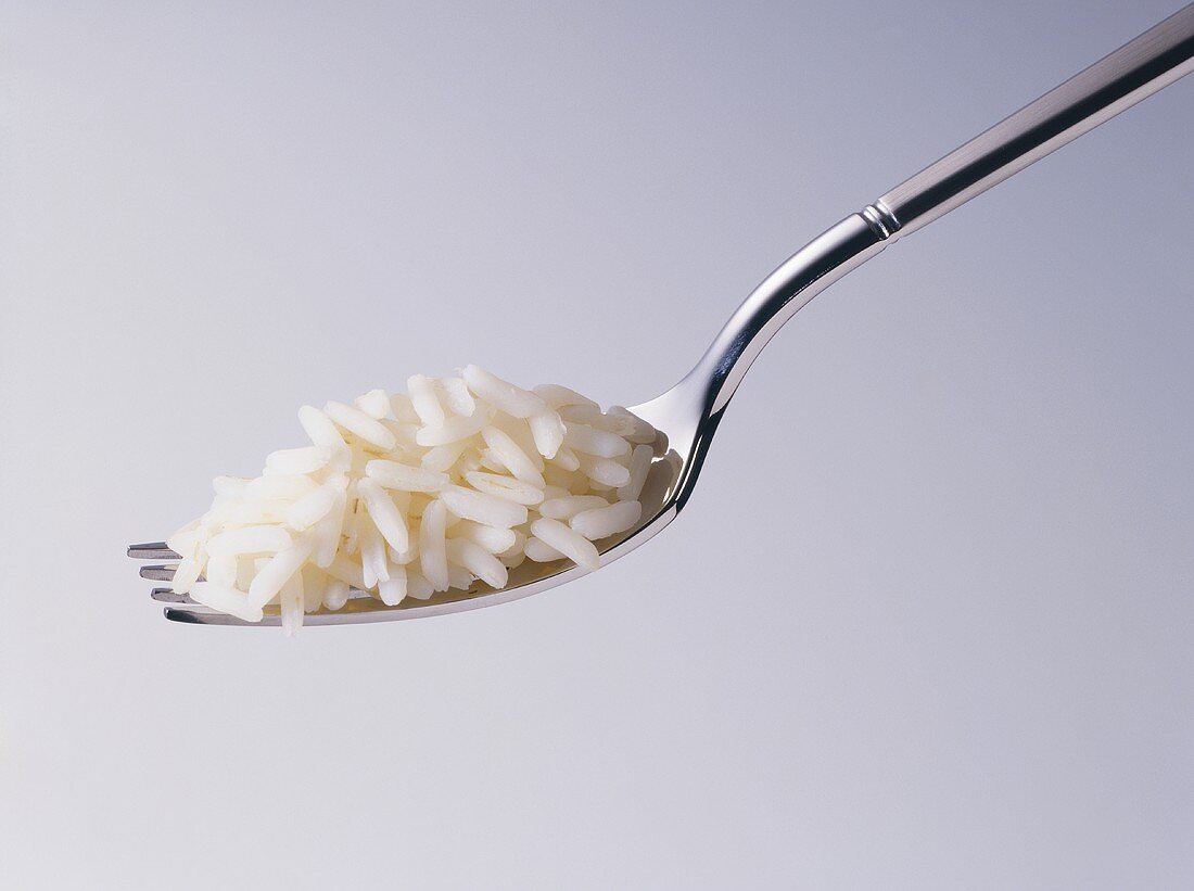 Cooked rice on fork