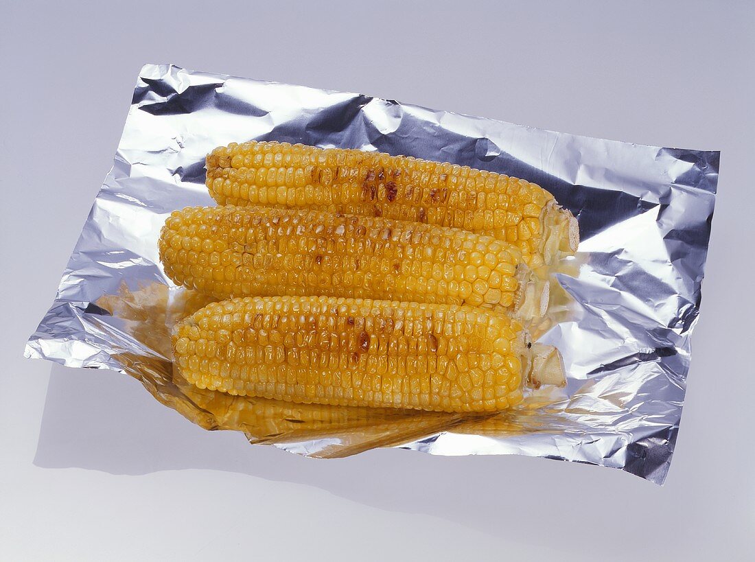 Grilled corn on the cob on aluminium foil