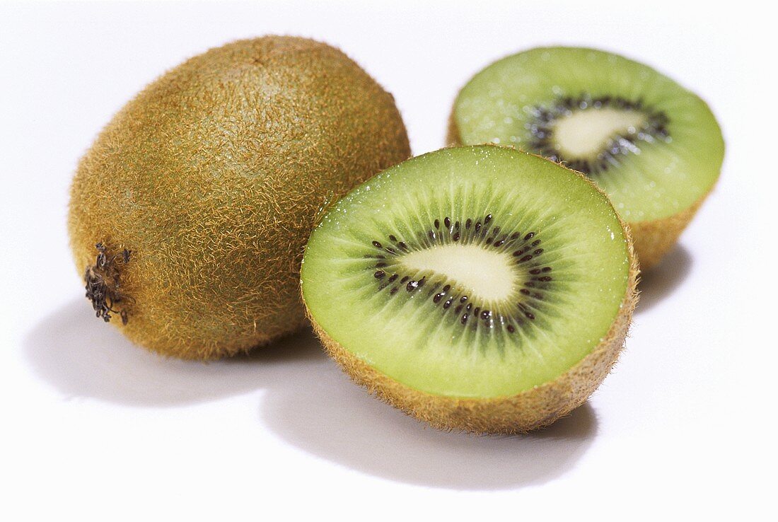 Kiwi fruit, one whole and one halved