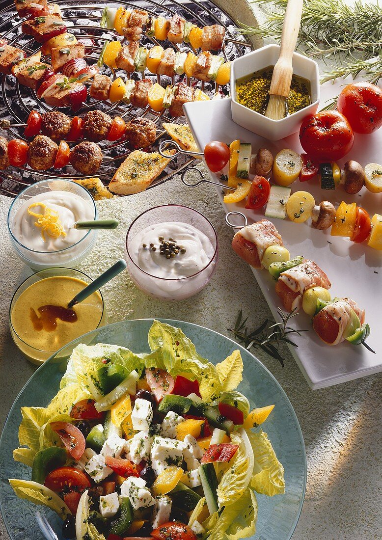 Mixed kebabs for grilling, sauces and mixed salad