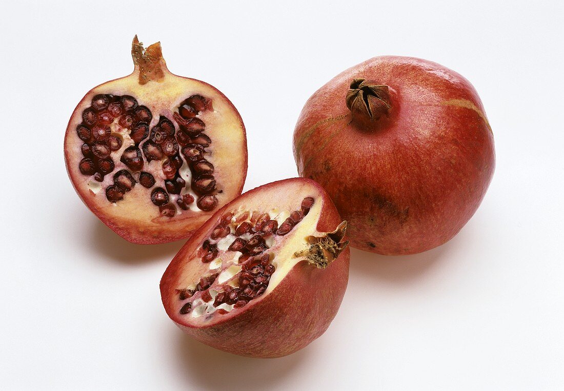 Whole pomegranate and halved pomegranate