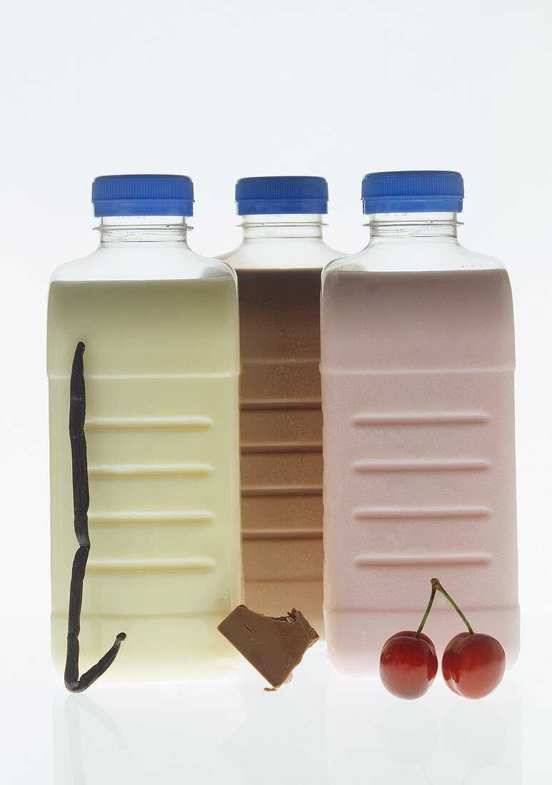 Vanilla, chocolate and cherry milk in plastic bottles