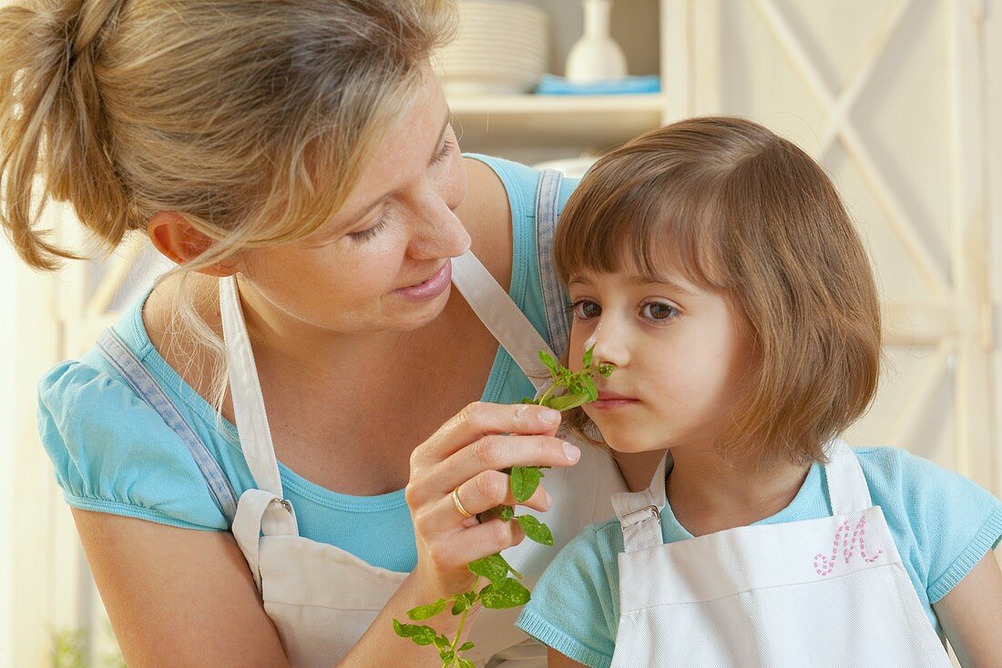 Mother and daughter with fresh basil