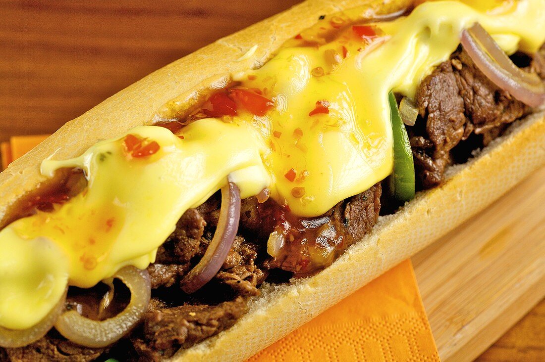 A baguette filled with beef and melted cheese