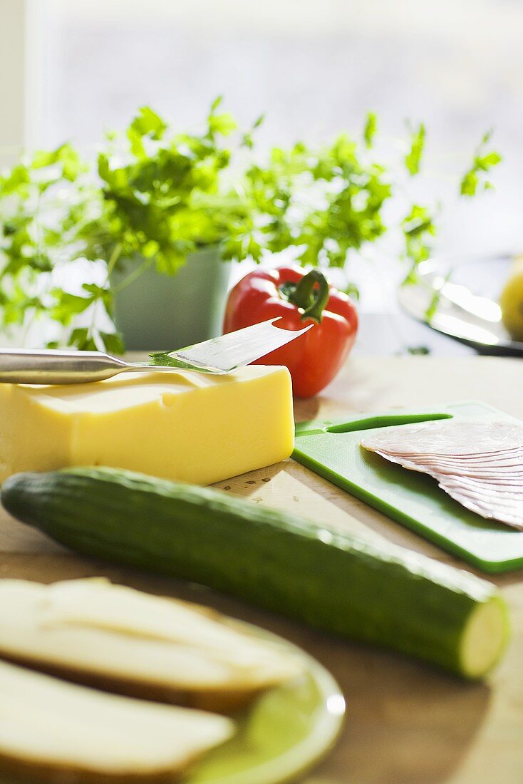 Cheese, vegetables, sausage and herbs in the kitchen