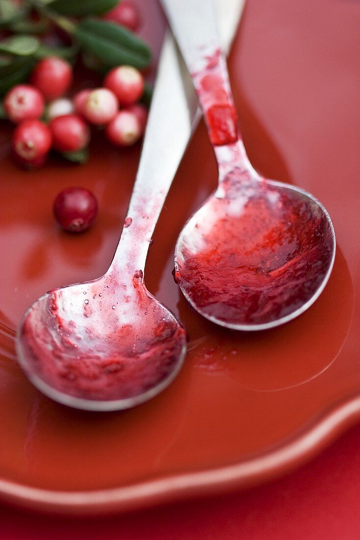 Two spoons with cranberry jam