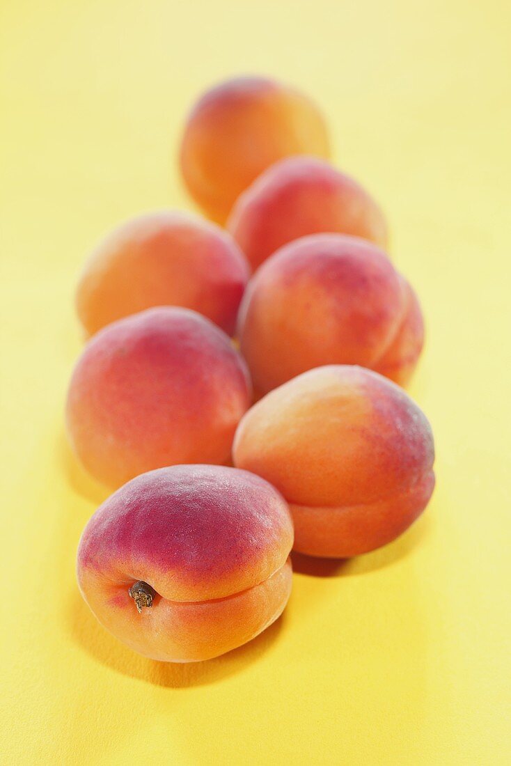 Several apricots on yellow background