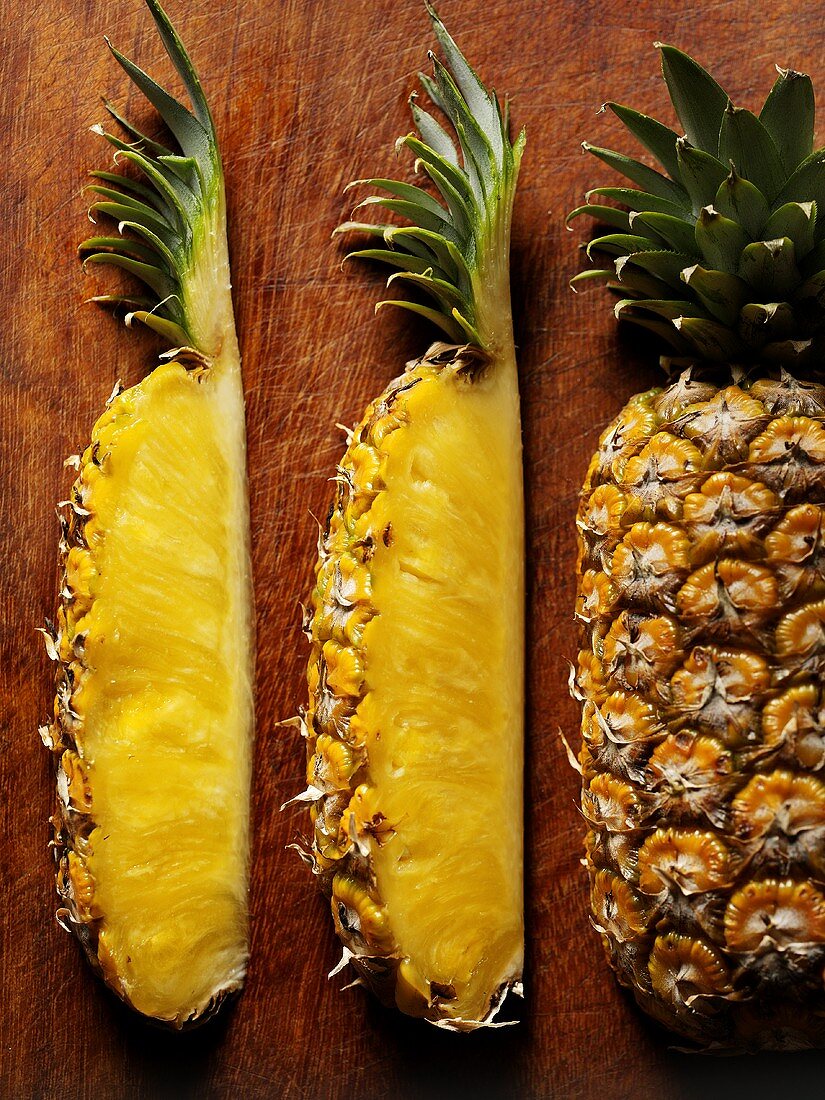 Wedges of pineapple on wooden background