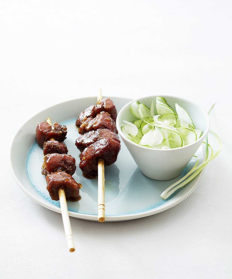 Pork skewers with cucumber salad