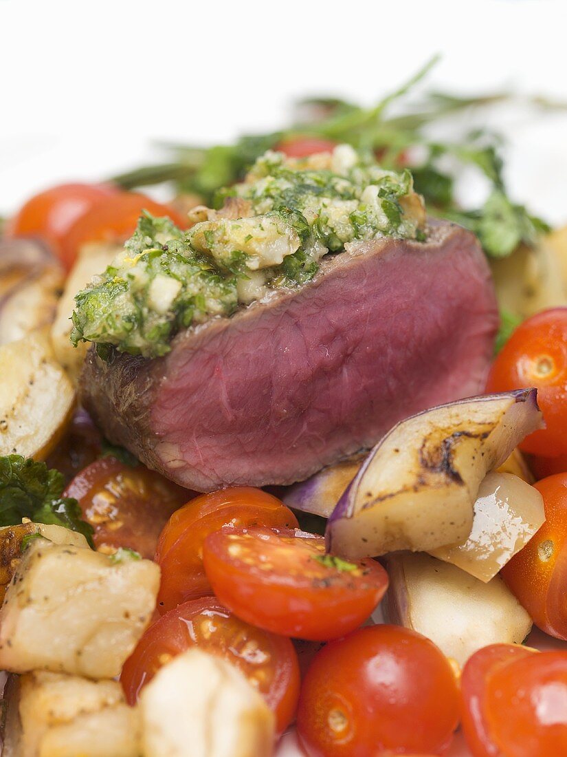 Beef sirloin with herb crust on bed of vegetables