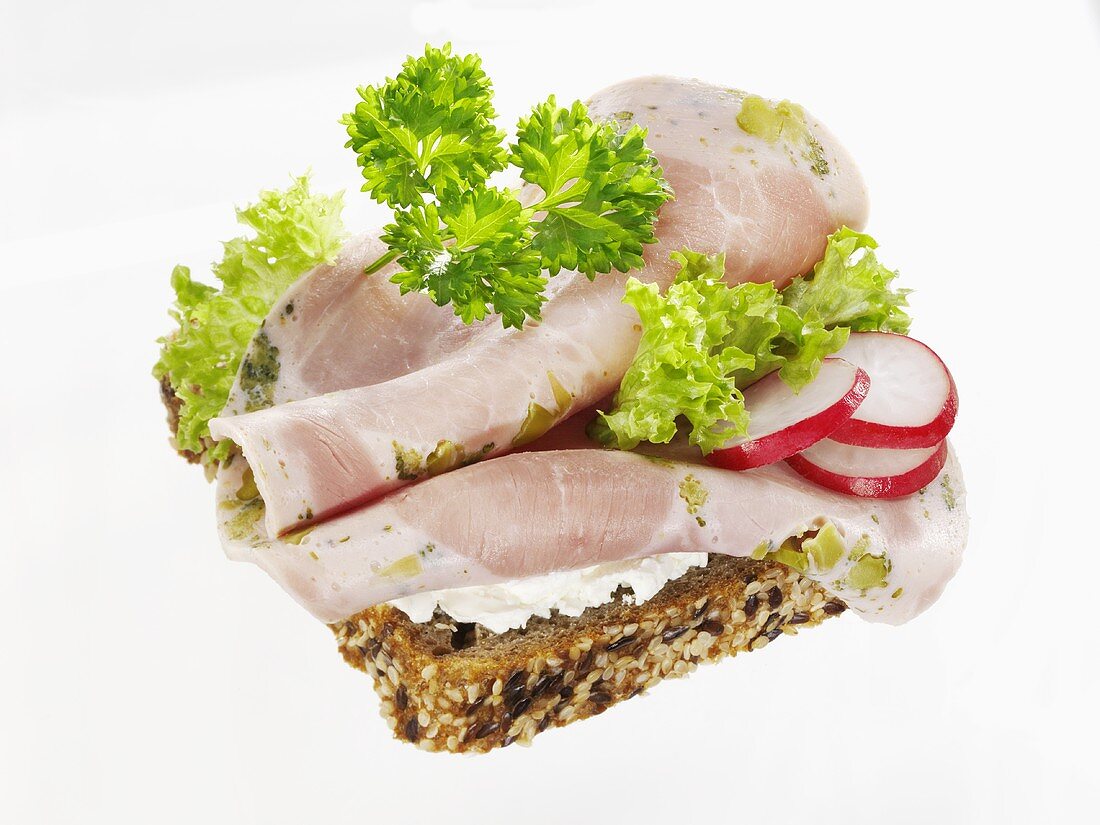 Open ham sandwich with radish slices