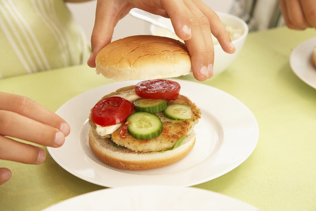 Preparing a fish burger