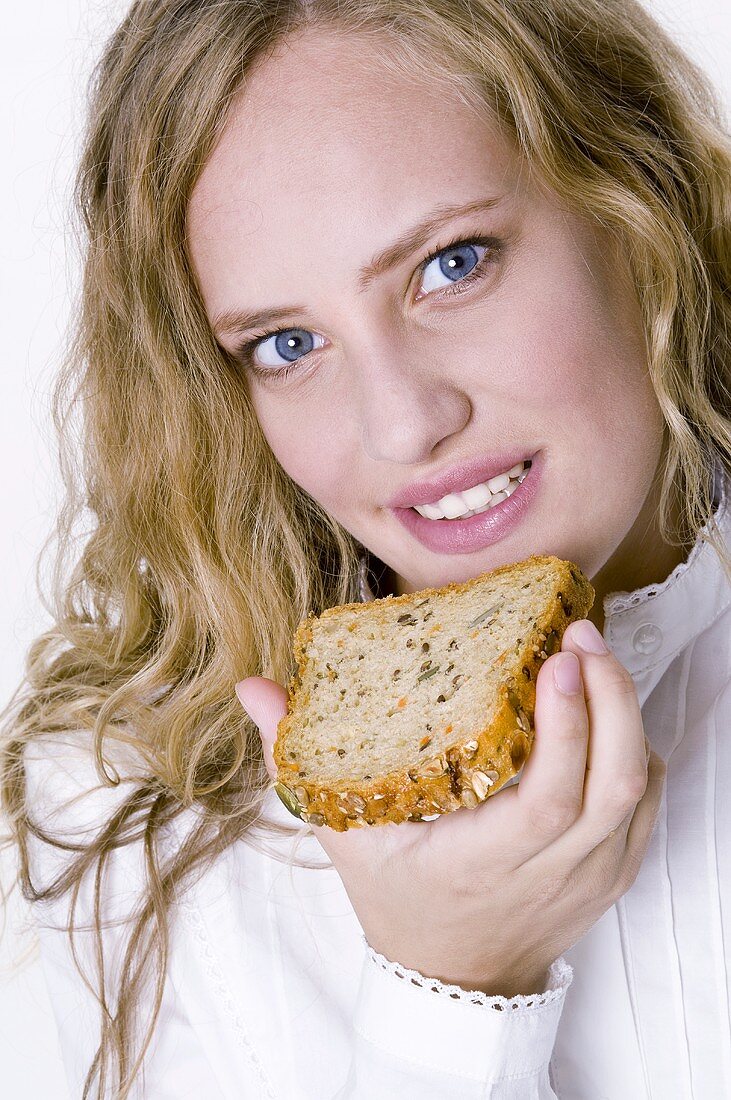 Woman holding a slice of grannary bread