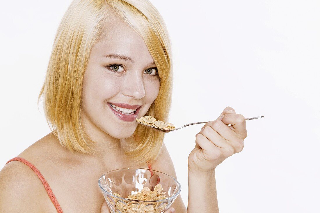 Woman with blond hair eating cornflakes