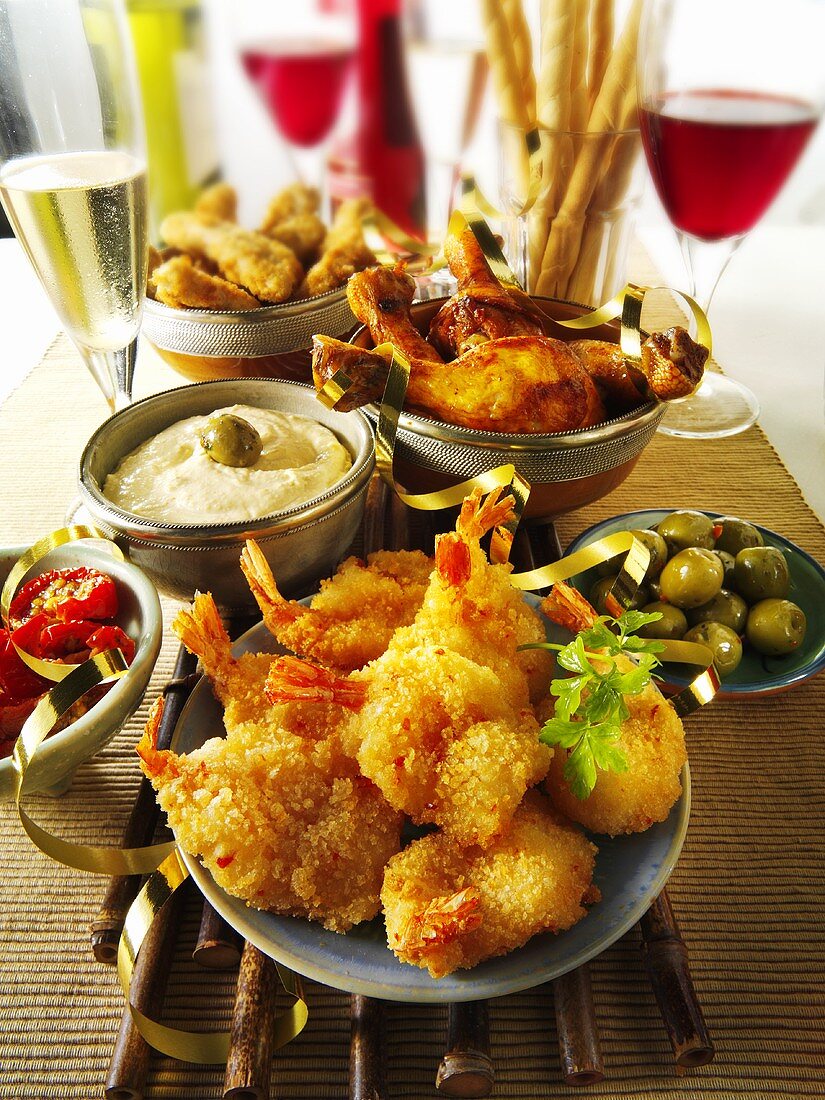 Party buffet with prawns, chicken, olives and a dip