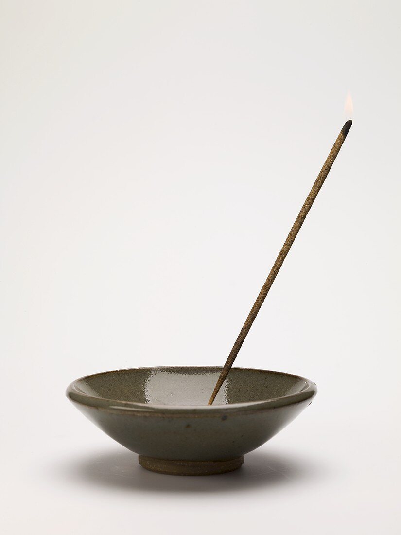 Incense stick in ceramic dish