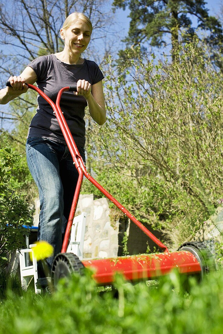 Woman mowing the lawn