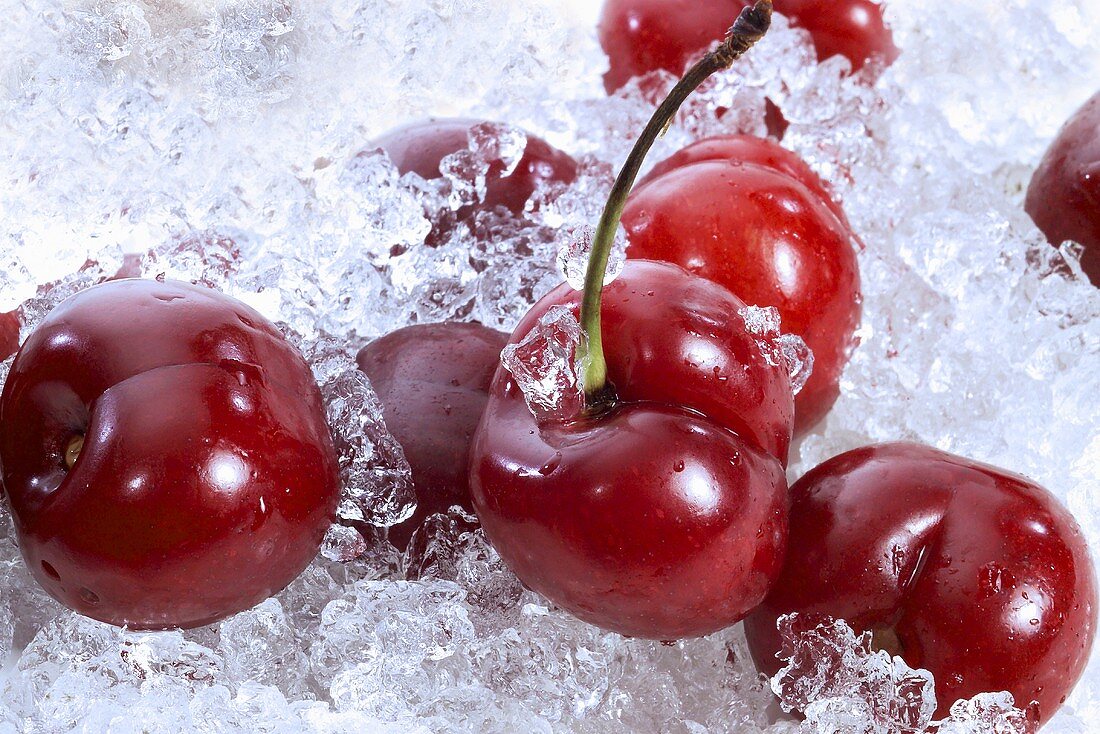Several fresh cherries on crushed ice