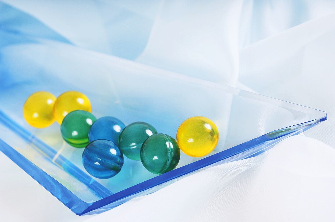 Bath pearls in glass dish