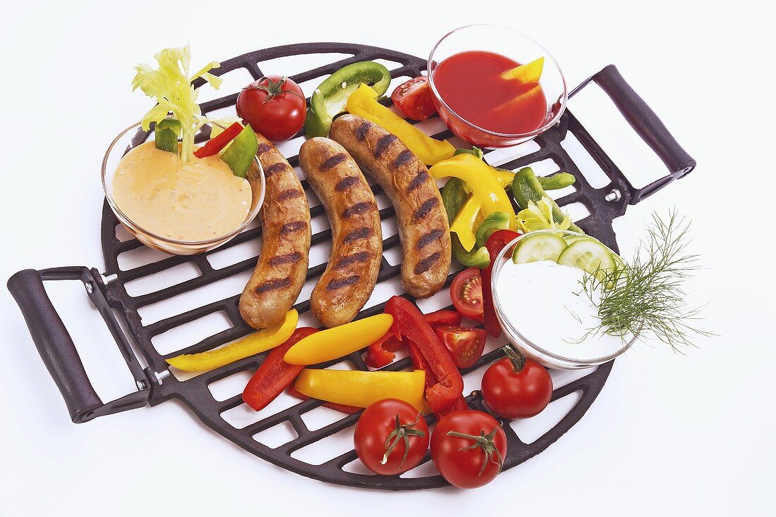 Grilled sausages with vegetables and dips