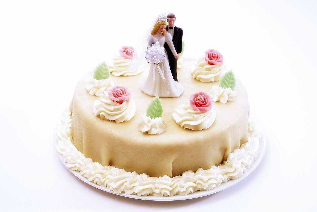 Wedding cake with bride and groom topper