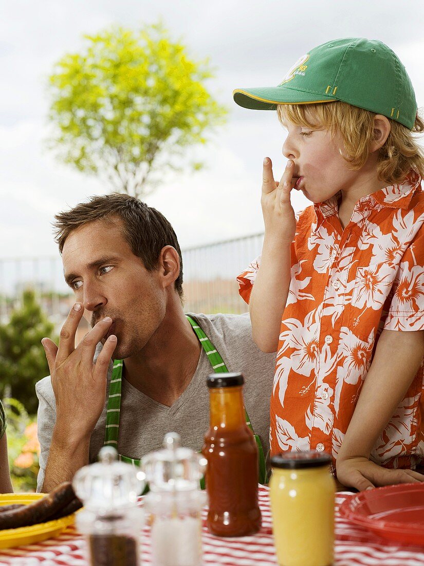 Father and son eating on balcony