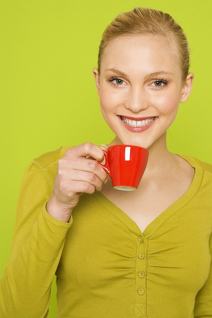 Young woman with a cup of espresso