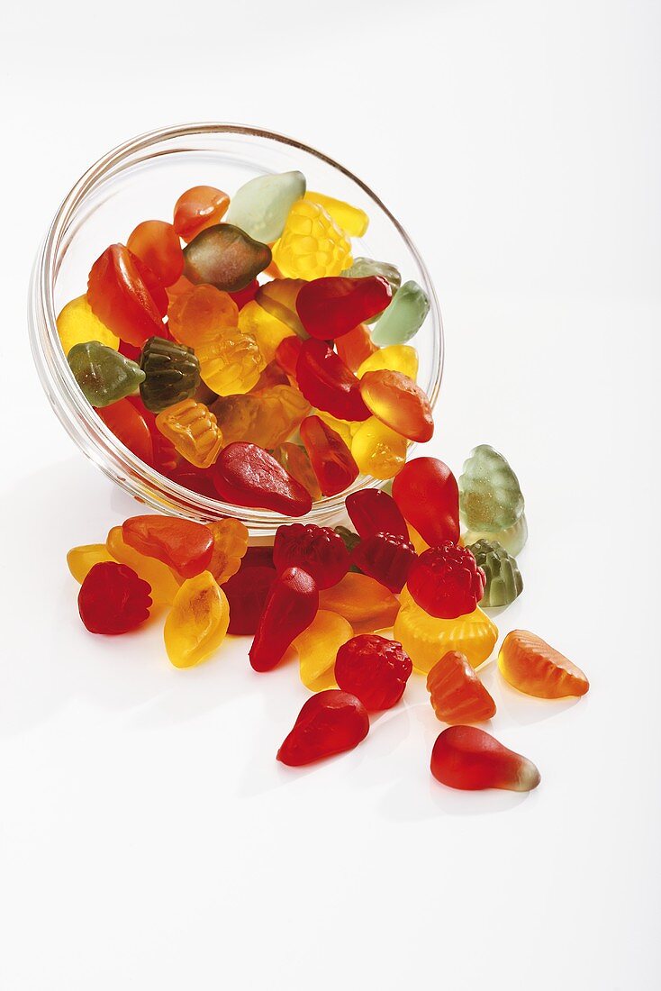 Mixed wine gums falling out of glass bowl