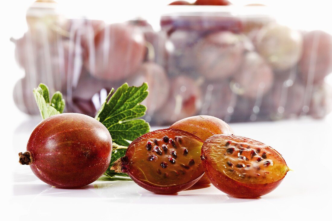 Gooseberries in and in front of plastic container