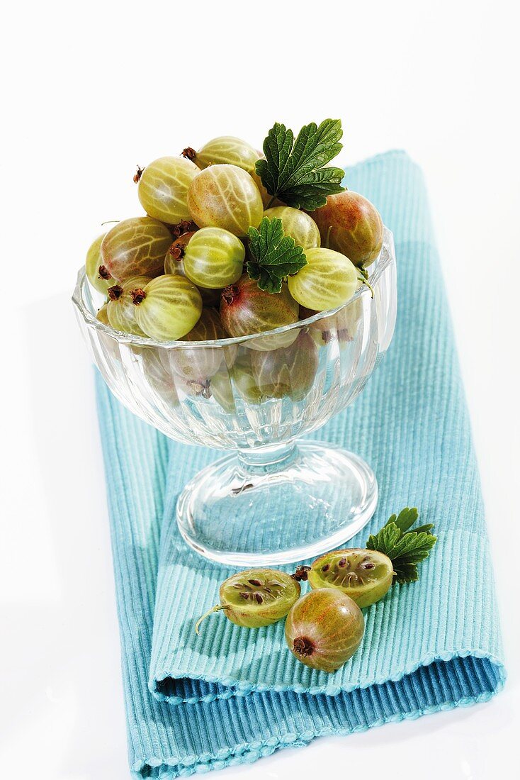 Gooseberries in dessert glass on table mat