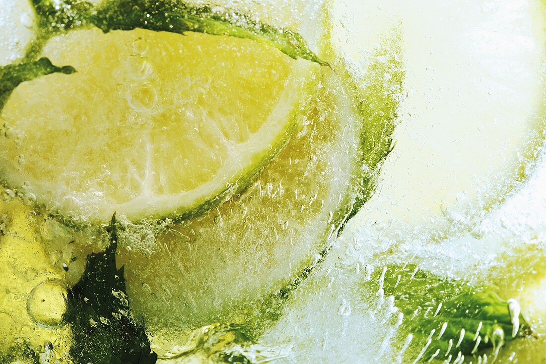 Limes in block of ice (close-up)