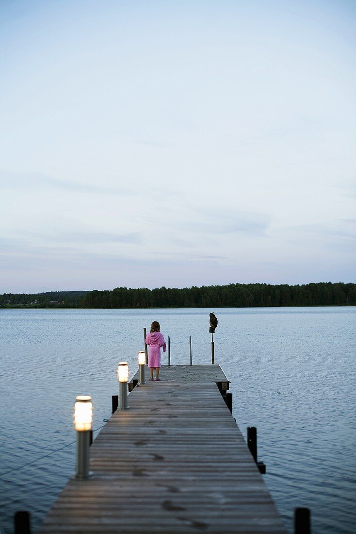 Girl on a lakeside landing stage